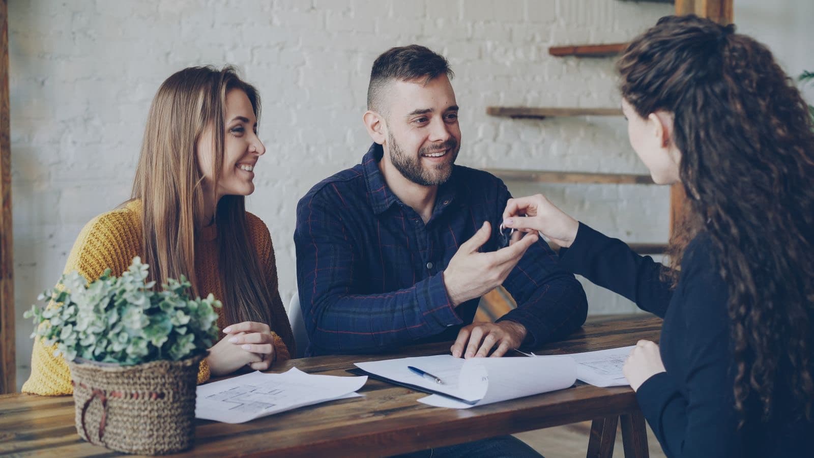 Couple receiving house keys from a property agent