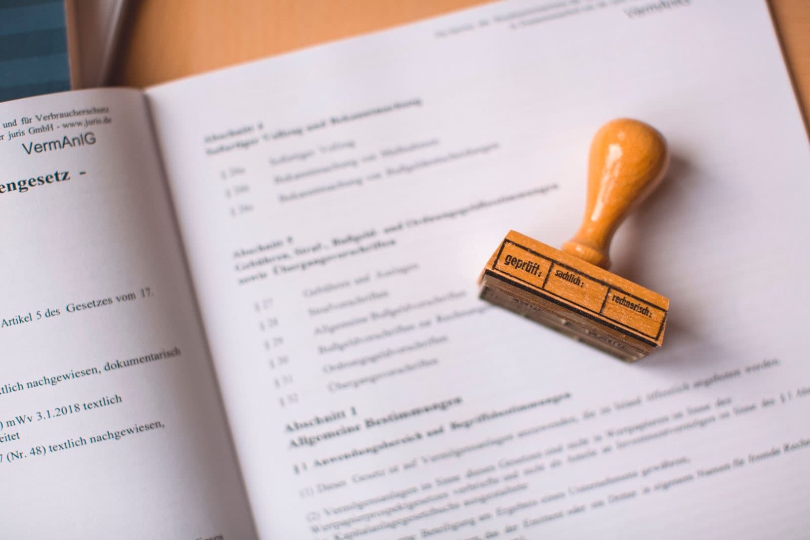 Approval stamp resting on an open legal document